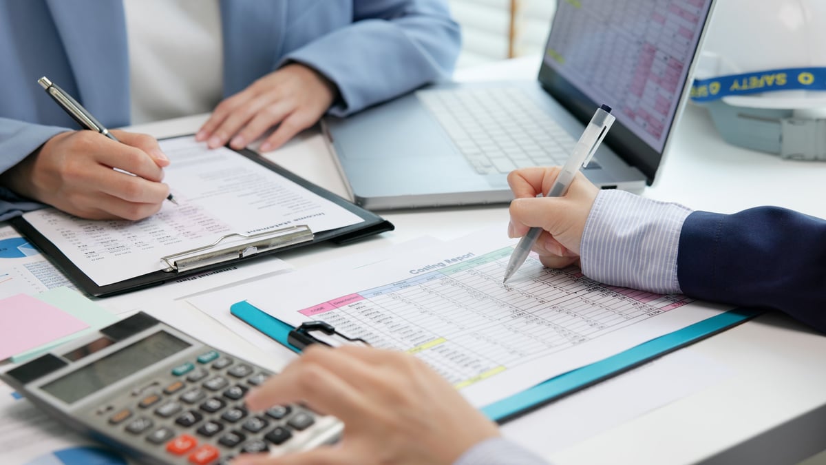 Professional accountant reviewing financial documents and annual reports for charity compliance